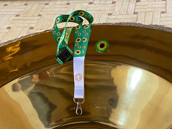 Solsikkesnor og solsikke-emblem liggende på døbefont