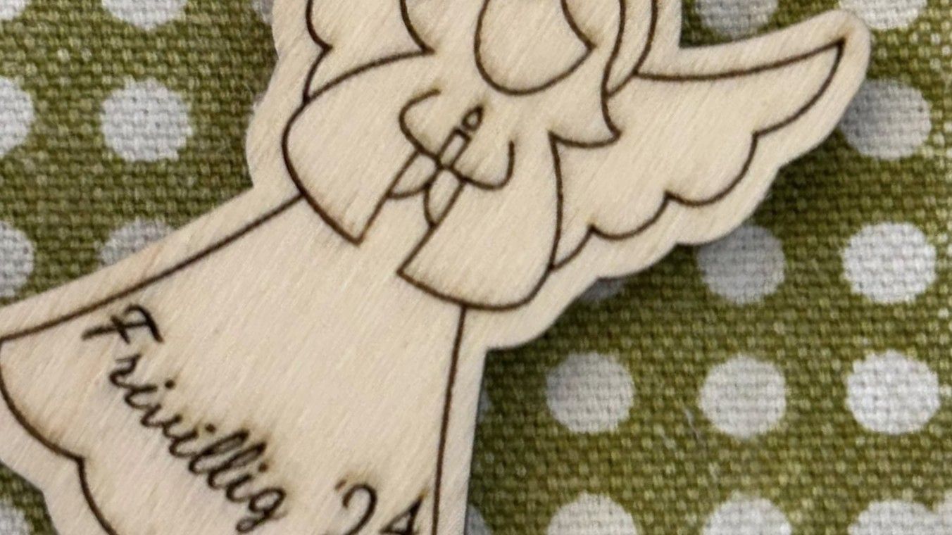 Mand siddende på bænk kiggende på flyvende fugl